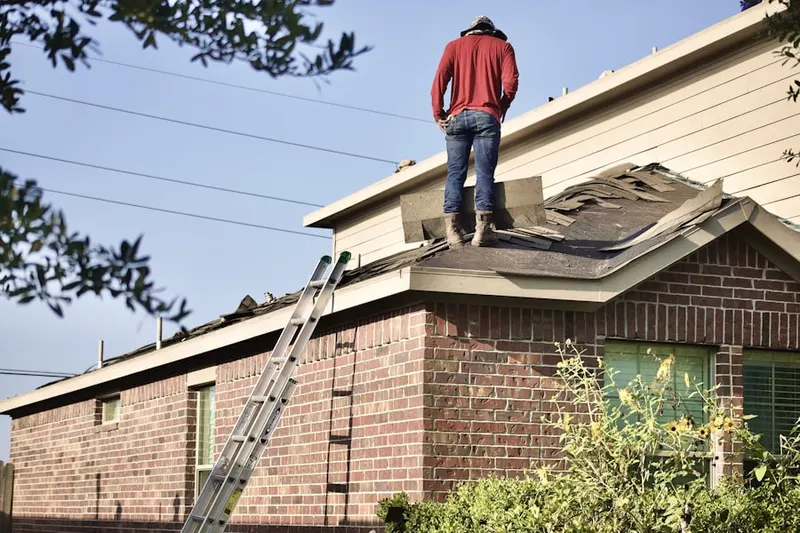 Professional roofer working on a residential roof in North Eastham